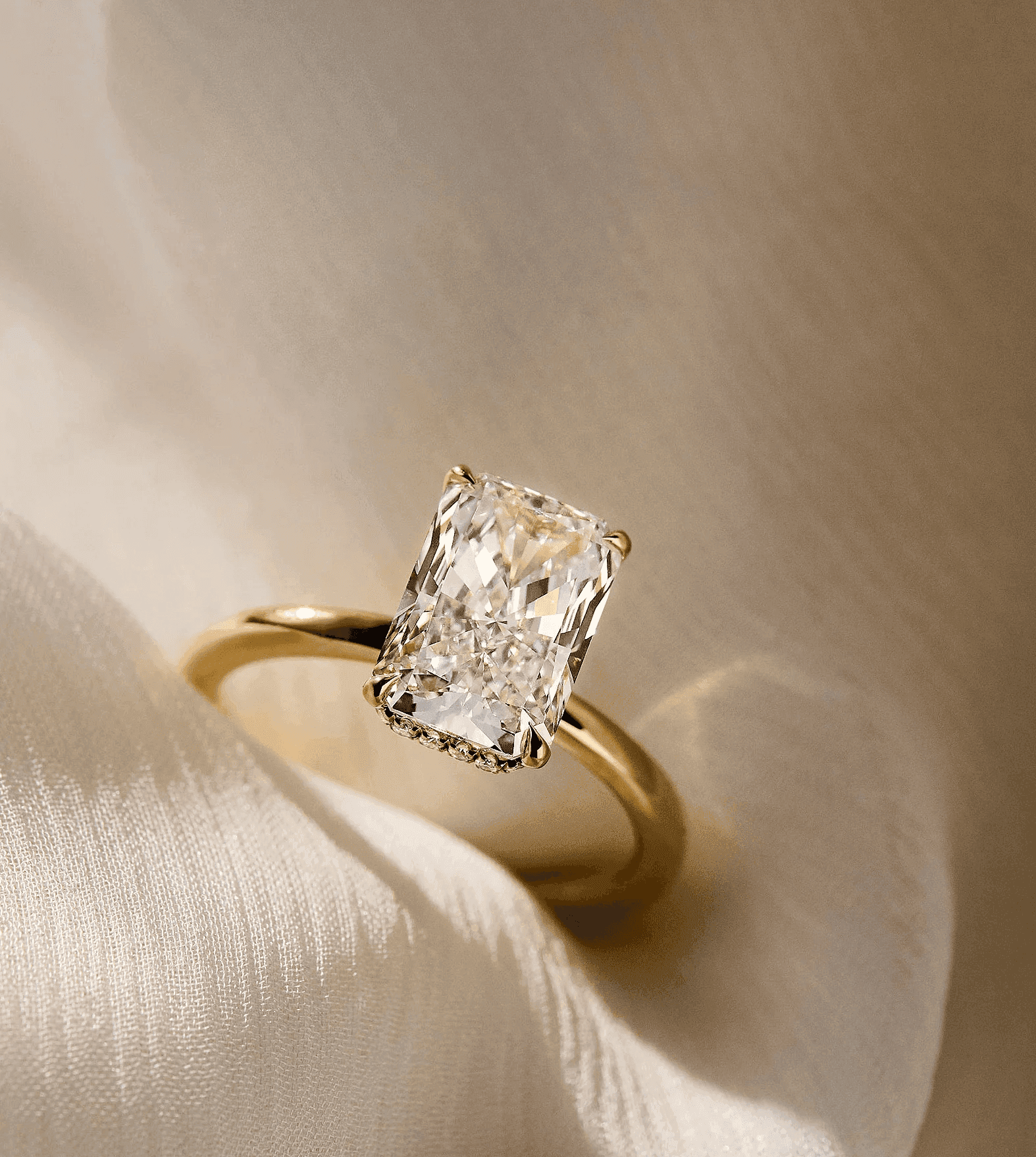 Radiant cut diamond engagement ring worn on a hand