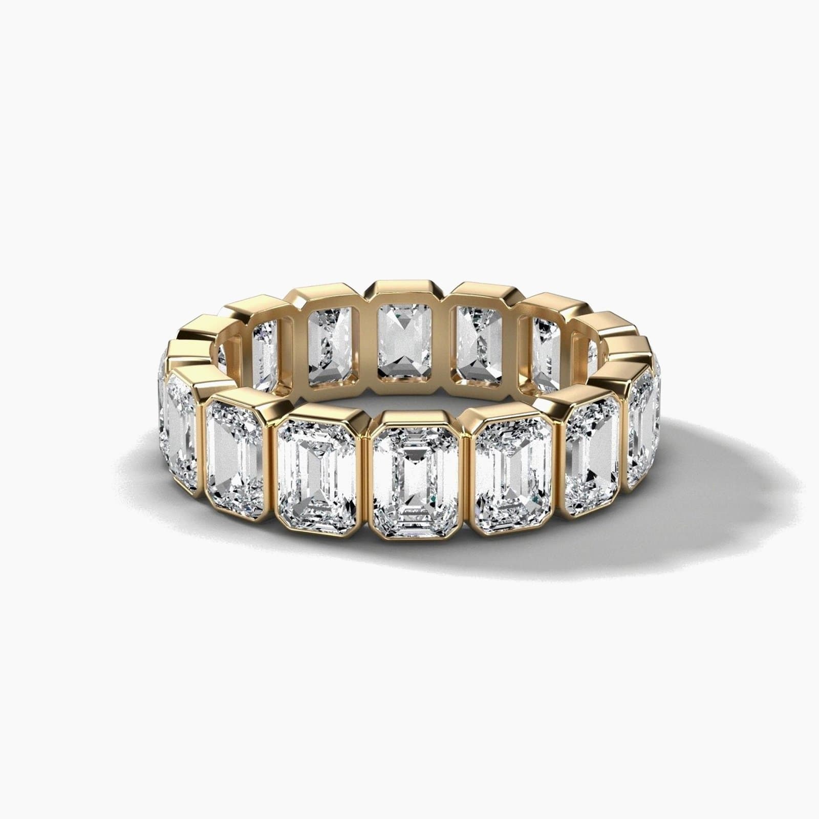 Bezel set emerald cut eternity band in yellow gold