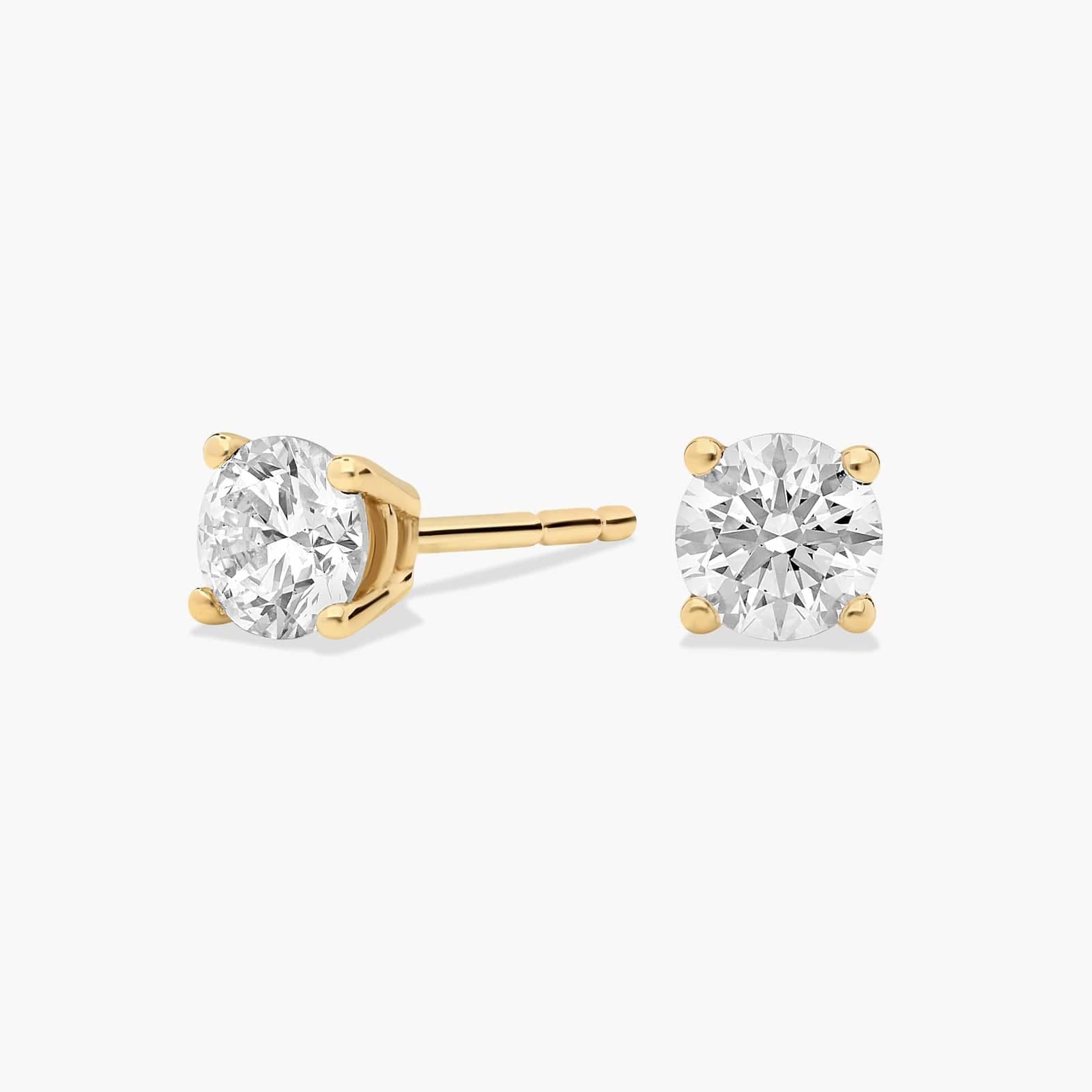 Four prong round diamond stud earrings, 1/2 ct total, in 14K yellow gold
