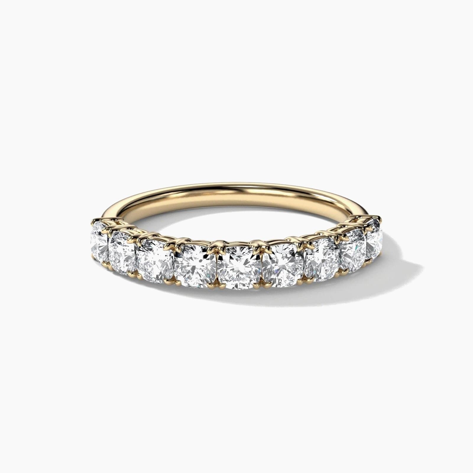Nine stone cushion cut diamond band in yellow gold
