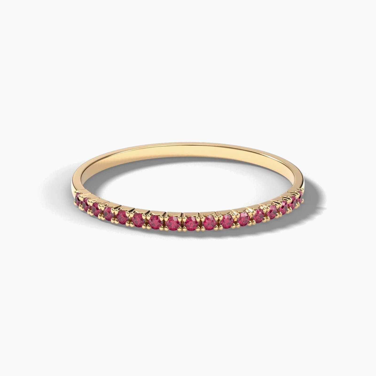 Petite French pavé ruby band in yellow gold