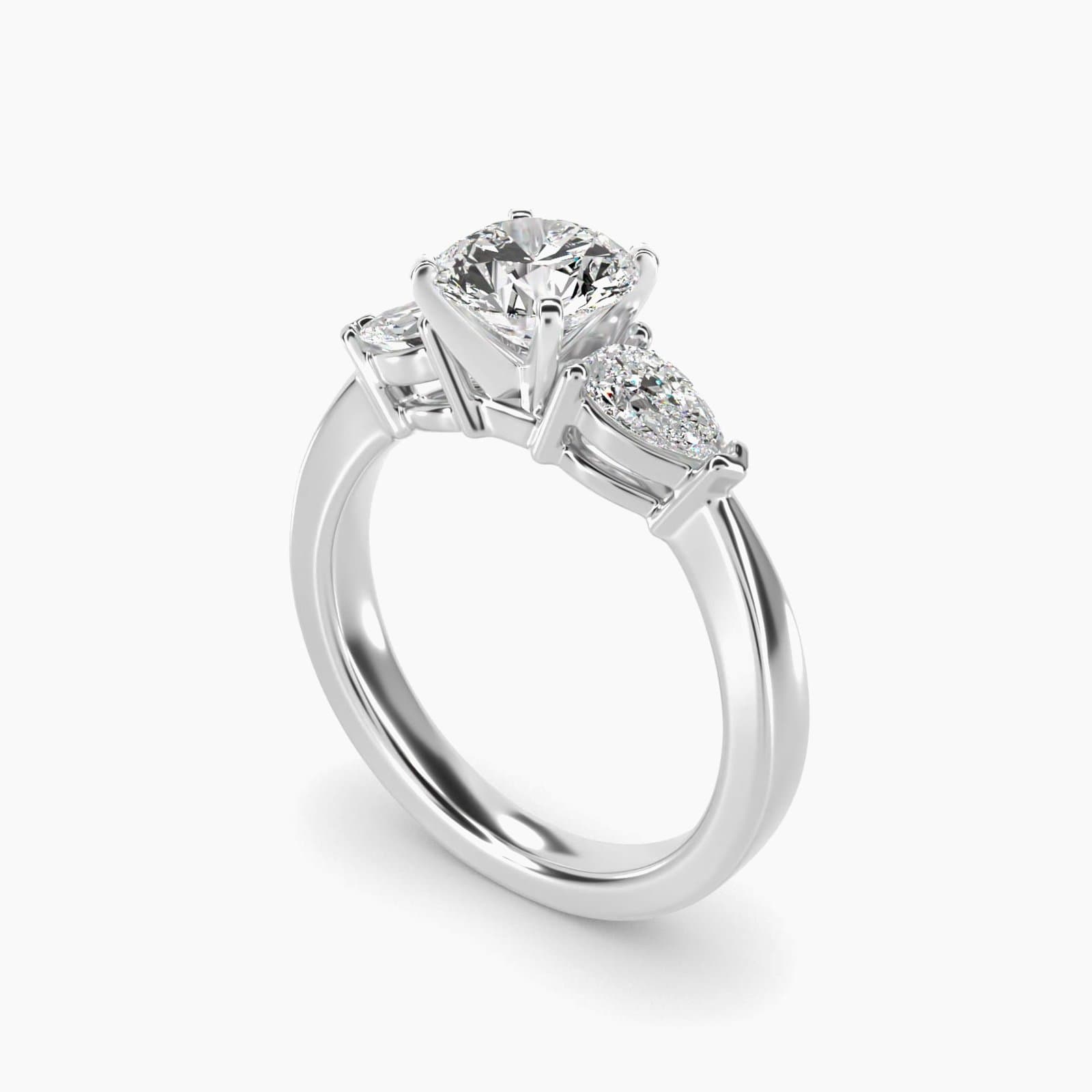 Round and pear three stone engagement ring in white gold