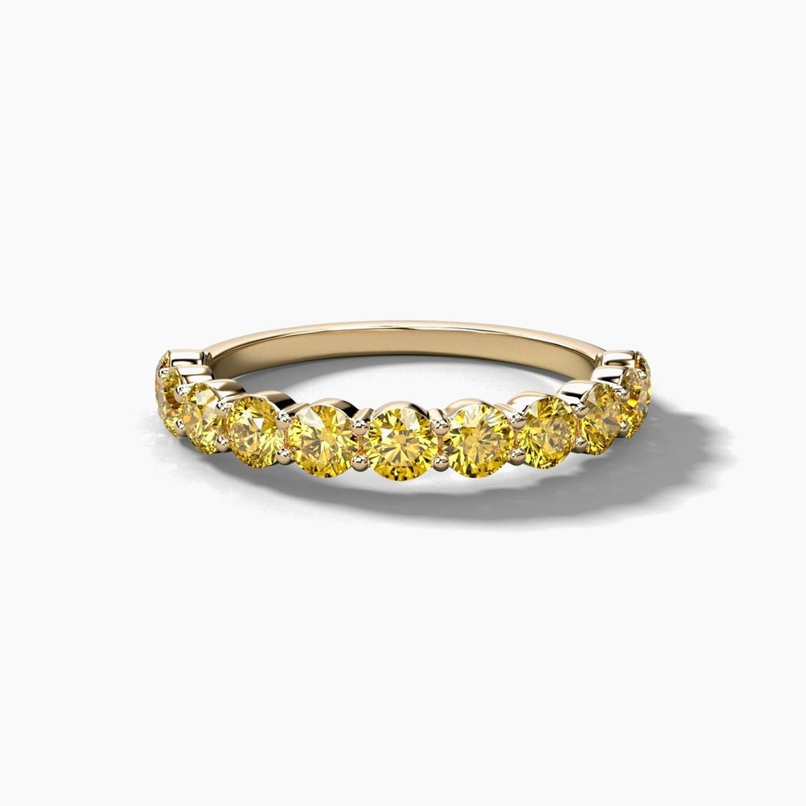 Shared prong canary yellow diamond band in yellow gold