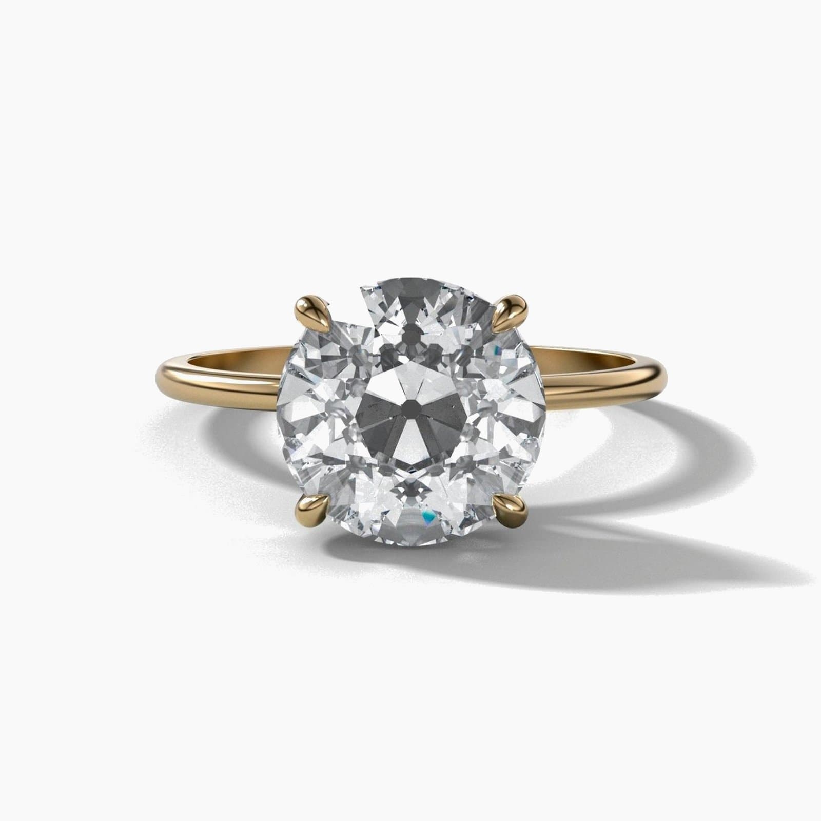 Thin solitaire engagement ring with an old European cut diamond in yellow gold