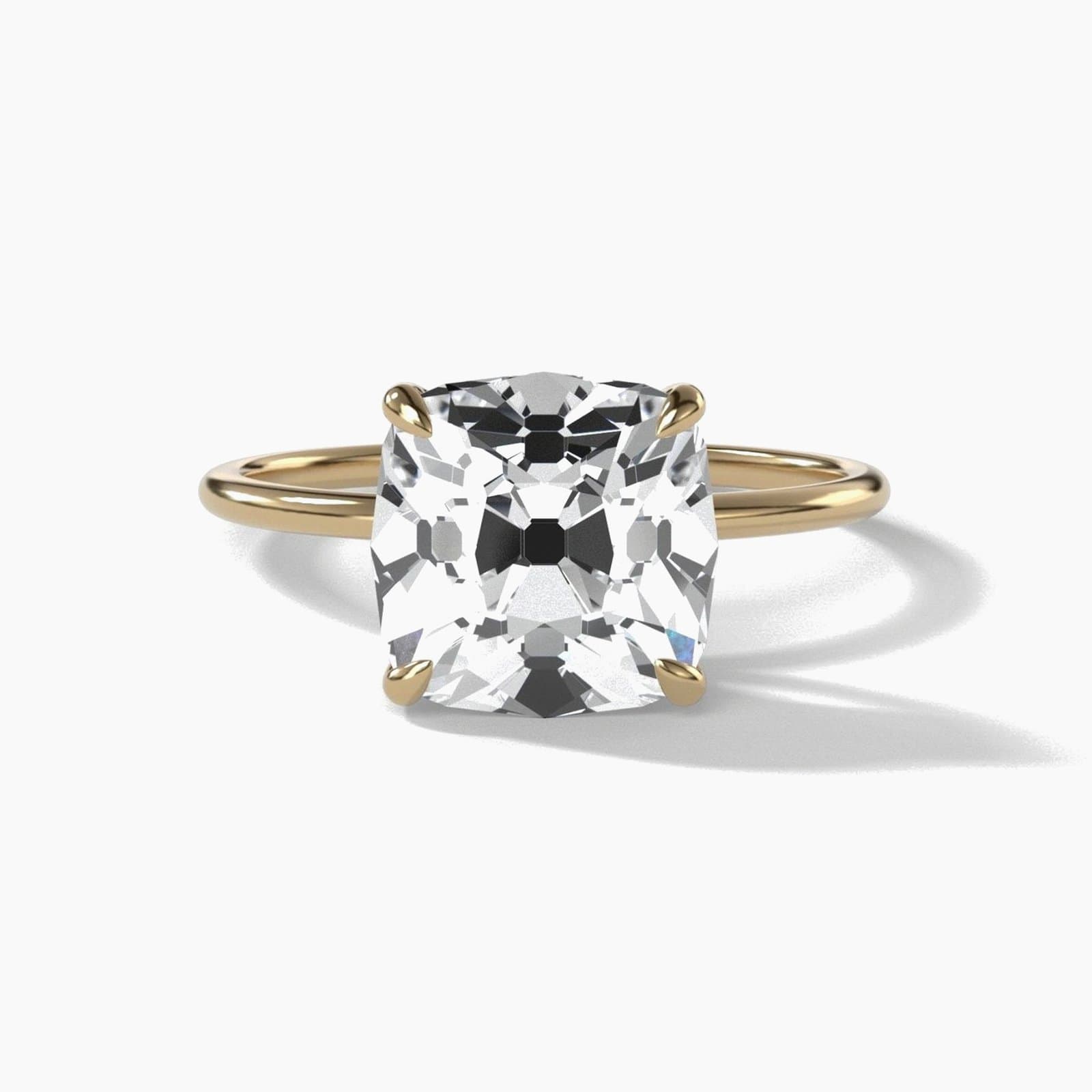 Thin solitaire engagement ring with an old mine cut diamond in yellow gold